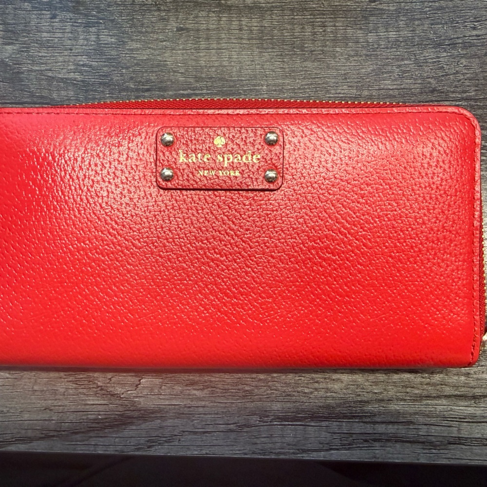 kate spade red pebbled leather zip-around wallet with gold logo